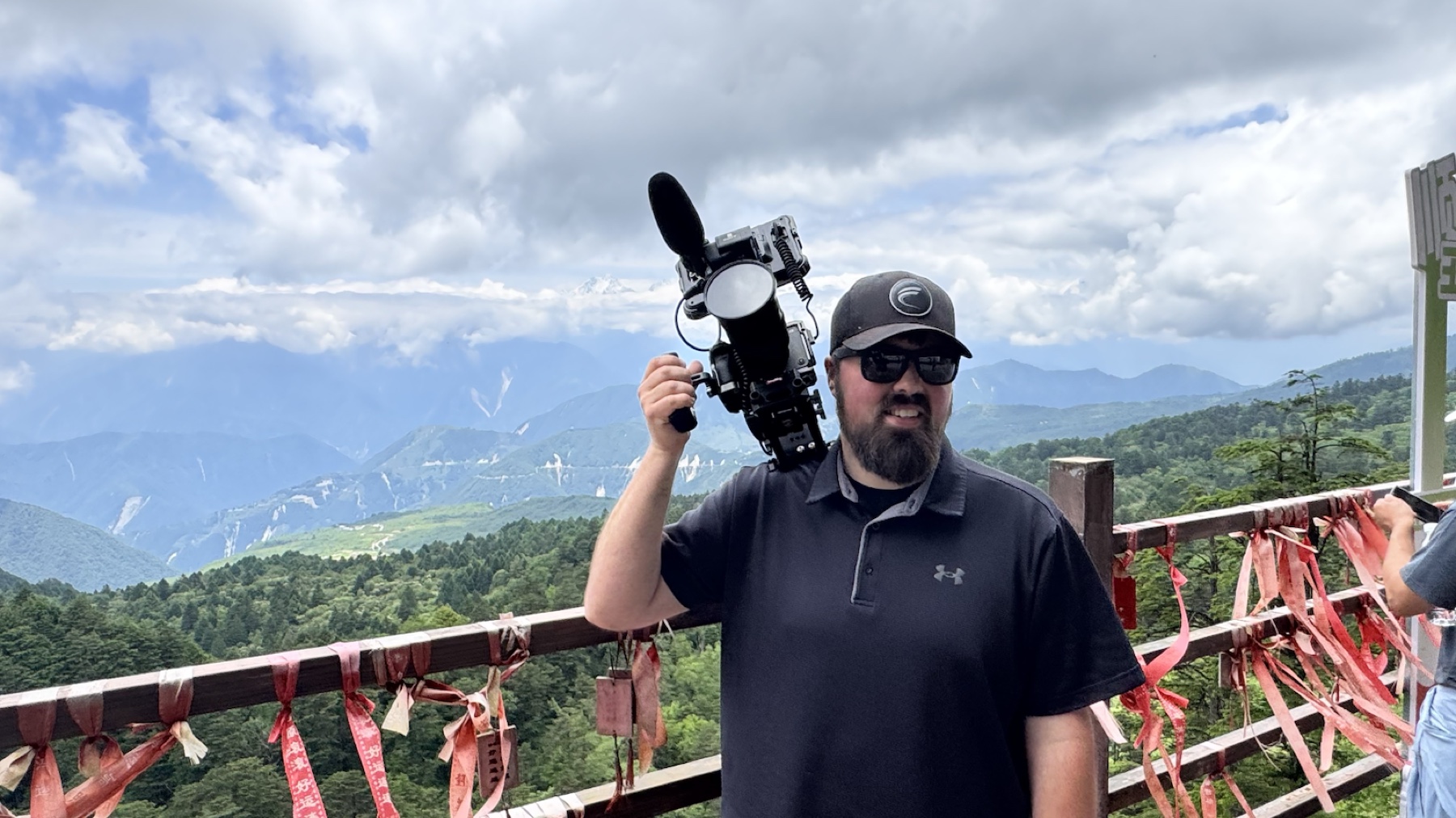 Arron carrying his camera rig in the mountains during a three-week production assignment in China